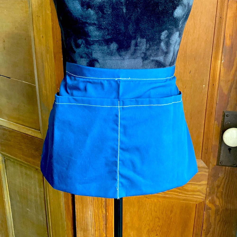 Apron with 2 large pockets. 17” length of apron. Tie around waist.